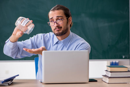 Young underpaid male teacher in the classroomの写真素材