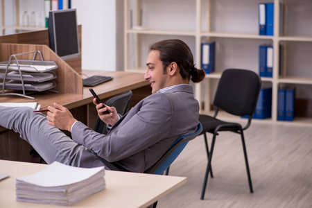 Young male employee working in the officeの写真素材