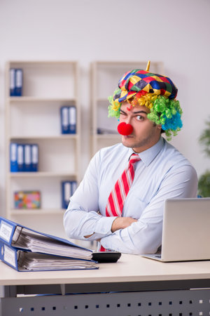 Funny employee clown working in the officeの写真素材
