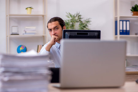 Young male employee sitting in the officeの写真素材