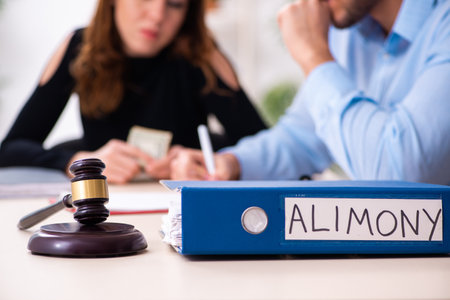 Young couple divorcing in alimony conceptの写真素材
