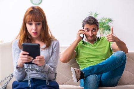 Young couple in gadget dependency conceptの写真素材