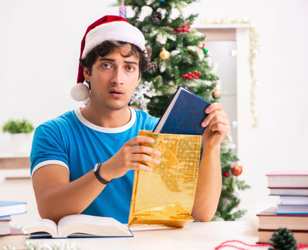 Young student with book at Christmas eveの写真素材