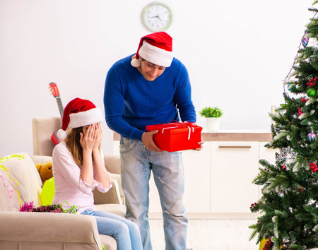 Young couple celebrating christmas at homeの写真素材