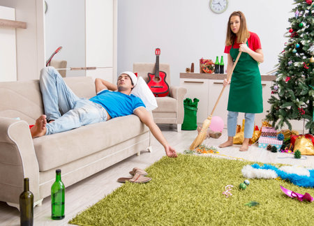 Young family cleaning apartment after christmas partyの写真素材