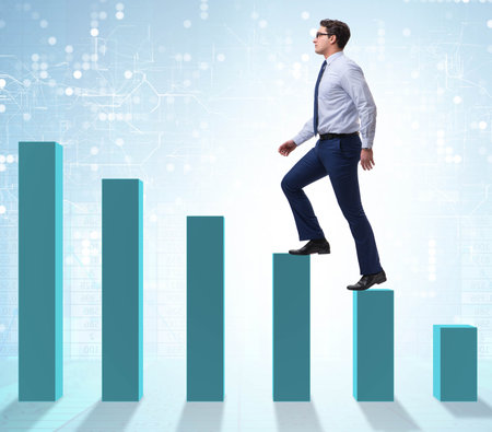 Businessman going up the bar chart in growth conceptの写真素材