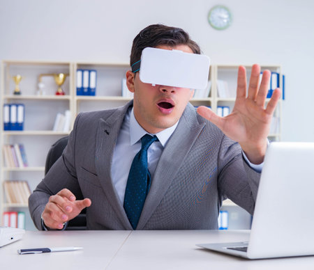 Businessman with virtual reality glasses in modern technology coの写真素材