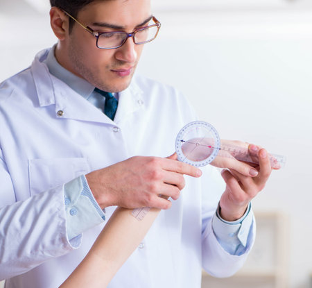 Doctor checking patients joint flexibilityの写真素材