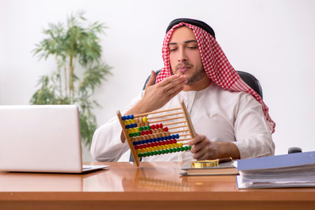 Young male arab employee working in the officeの写真素材