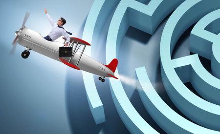 Businessman escaping from maze on airplaneの写真素材