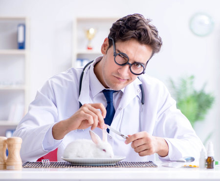 Mad crazy doctor preparing to eat rabbitの写真素材