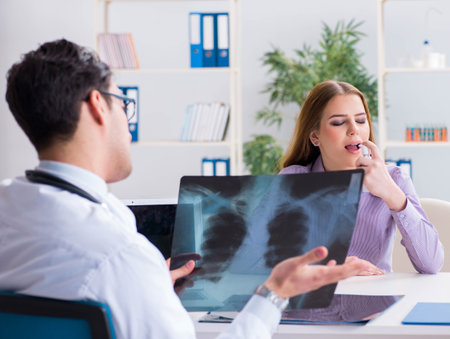 Doctor examining x-ray images of patientの写真素材