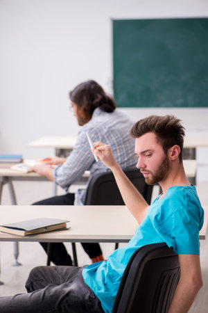 Two male pupils in bullying concept in the classroomの写真素材