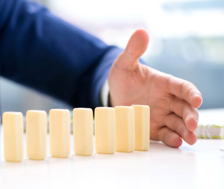 Young businessman playing with domino in officeの写真素材