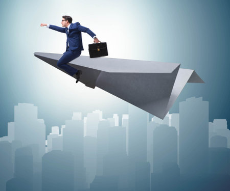 Businessman flying on paper plane in business conceptの写真素材