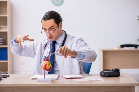 Young male doctor lecturer cardiologist working in the clinicの写真素材