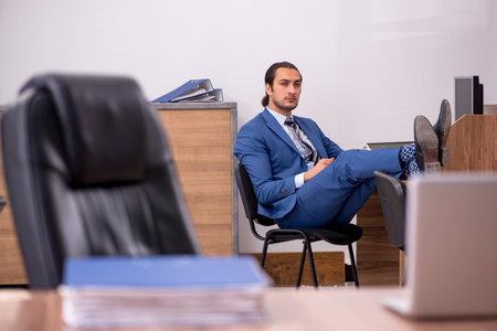 Young male employee sitting at workplaceの写真素材