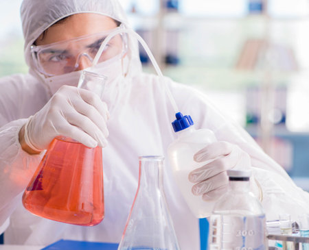 Chemist working in the laboratory with hazardous chemicalsの写真素材
