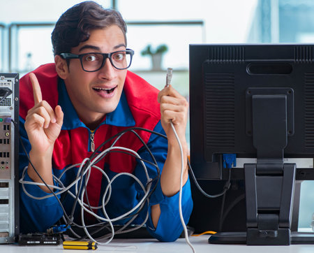 Computer repairman working on repairing computer in IT workshopの写真素材