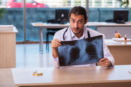 Young male doctor radiologist working in the clinicの写真素材