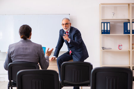 Two businessmen in the classroom in pandemic conceptの写真素材