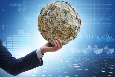 Businessman with heavy dollar ballの写真素材