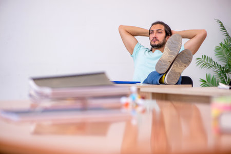 Young male student in the classroom during pandemicの写真素材