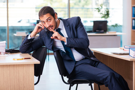 Young male employee working in the officeの写真素材