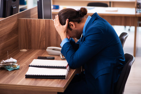 Young male employee working in the officeの写真素材