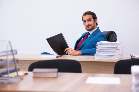Young male employee working at workplaceの写真素材