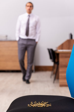 Ofice prank with sharp thumbtacks on chairの写真素材