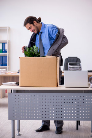 Young male employee being fired from his workの写真素材
