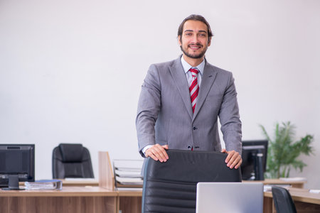 Young male employee working in the officeの写真素材
