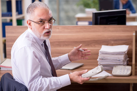 Two businessmen employees working in the officeの写真素材