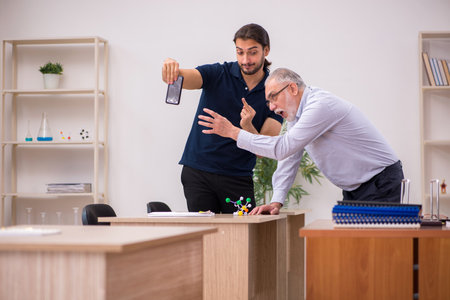Old male teacher feeling bad during individual lessonの写真素材