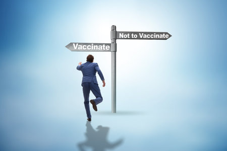 Businessman facing dilemma of vaccinationの写真素材