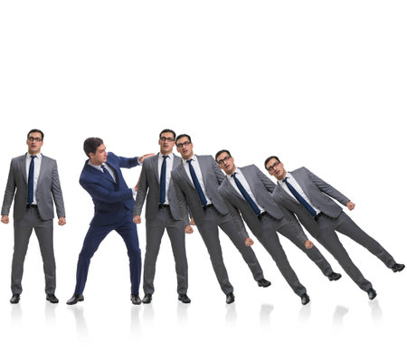 Businessman in domino effect business conceptの写真素材