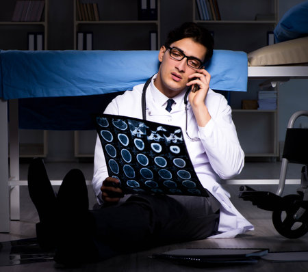 Doctor working night shift in hospital after long hoursの写真素材