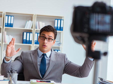 Business blogger doing webcast for his subscribersの写真素材