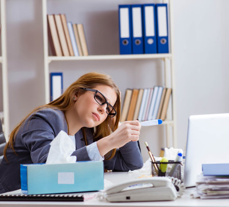 Businesswoman employee sick in the officeの写真素材