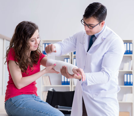Doctor and patient during check-up for injury in hospitalの写真素材