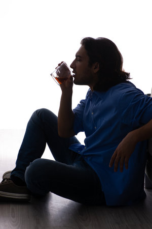 Young man suffering from alcoholismの写真素材