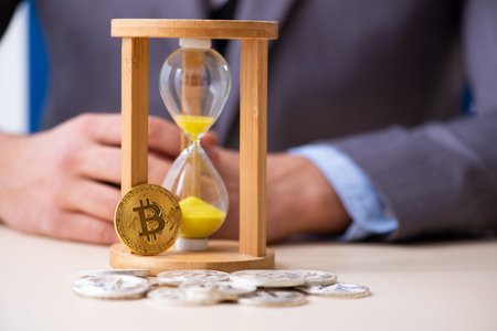 Young man earning money via Internet in time management conceptの写真素材