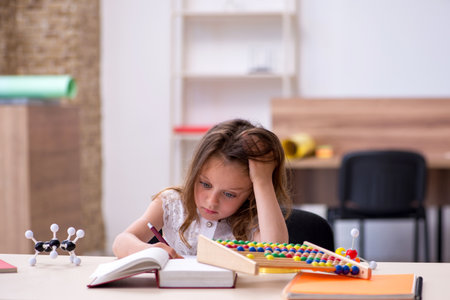 Small girl preparing for exams at homeの写真素材