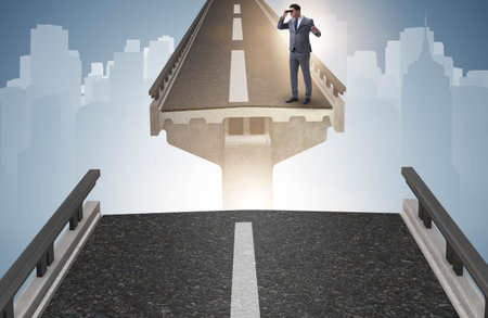 Businessman ready to overcome the broken bridgeの写真素材