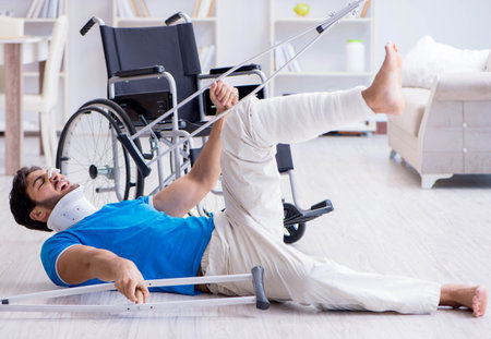Injured young man recovering at homeの写真素材