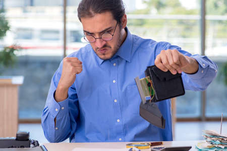 Young male bookkeeper in budget planning concept