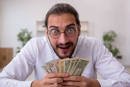 Young male bookkeeper in budget planning concept