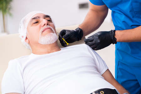 Old man visiting male doctor for plastic surgery