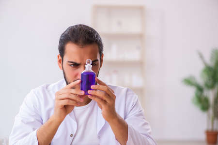 Young male chemist testing soap in the labの写真素材